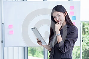 asian young business woman holding Digital tablet Computer isolated on White board background in office.smiling secretary girl