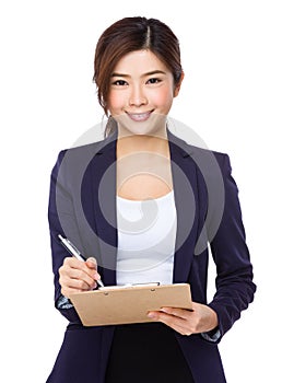 Asian Young businesswoman take note on clipboad