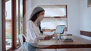 Asian young businesswoman is working at cafe using her laptop with focus