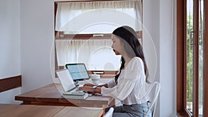 Asian young businesswoman is working at cafe using her laptop with focus