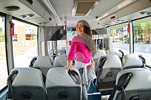 Asian young cheerful woman traveling by bus .