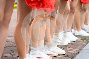 Asian young cheerleader group closeup with legs standing on row