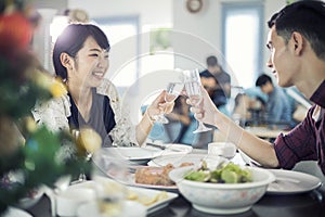 Asian young couple enjoying a romantic dinner evening drinks wh