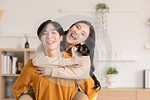Asian young couple hugging with positive emotion and loving together at warmth place. Attractive man and woman embracing spending