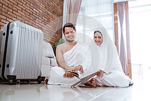 Asian young couple praying with Al-Qur`an and prayer beads