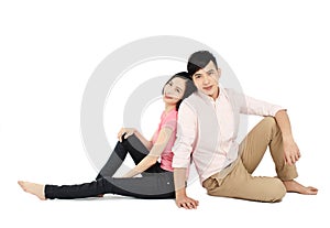 Asian young couple sitting on floor isolated on white background