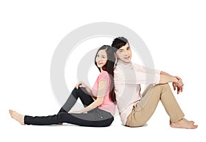 Asian young couple sitting on floor isolated on white background