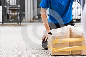 Delivery man he emotional courier hold damaged cardboard box is broken