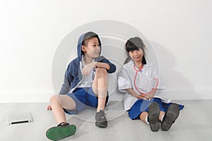 Asian young doctor and patient sitting on gray