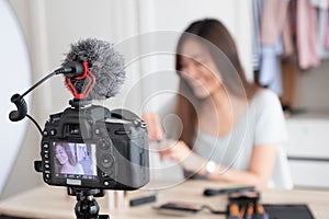 Asian young female blogger recording vlog video with makeup cosmetic at home online influencer on social media