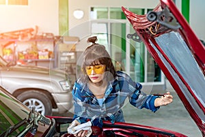 Asian young female car repair worker