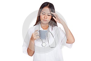 Asian young female doctor got headache with a cup of coffee