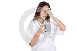 Asian young female doctor got headache with a cup of coffee