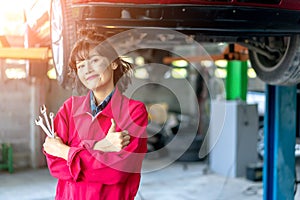 Asian Young Female Mechanics Smiling and Giving Thumb Up