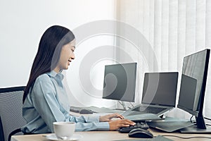 Asian young female programmer working developer programing on a computer code at office photo