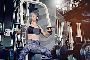 Asian young fitness woman execute exercise with exercise-machine