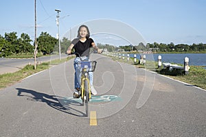 Asian young girl and  with bicycle at park