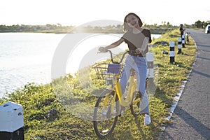 Asian young girl and  with bicycle at park