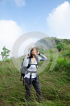 Asian young girl is trekking on mountain route with smile face o