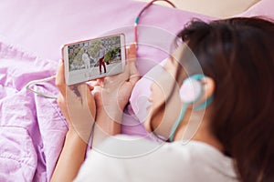 Asian young girl watching mobile video smart phone