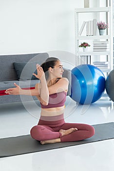 Asian young healthy woman in sportware practicing yoga at home, Sport girl meditating in living room at home