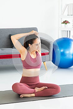 Asian young healthy woman in sportware practicing yoga at home, Sport girl meditating in living room at home