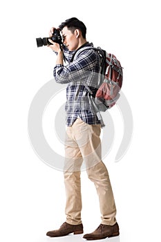 Asian young male backpacker take a picture photo