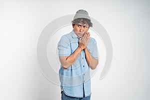 asian young man feeling scared over isolated background