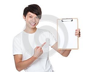 Asian young man finger point to blank page of clipboard