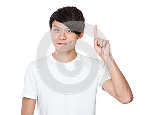 Asian young man finger point upwards