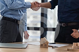 Asian young man hand shake after signed contact home purchase