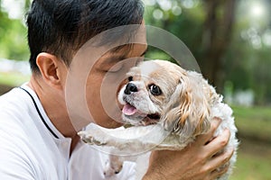 Asian young man with his Shih Tze dog