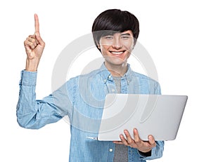 Asian young man with laptop computer and finger point up