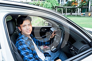 Asian young man sitting in the car prepare to leave