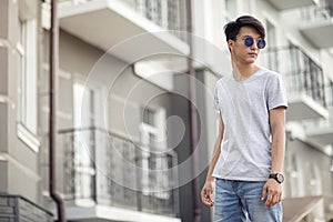 Asian young man wearing sunglasses outdoors