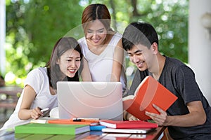 Asian young man and woman sitting pointing studying examining