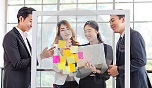 Asian young millennial professional successful male businessman and female businesswoman employee colleague in formal suit stand