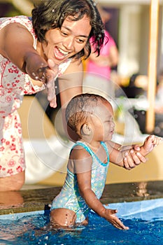 Asian Young Mother Encourage Toddler Having Fun at Swimming Pool