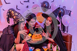 Asian young people in costumes celebrating halloween. Group of friends having fun at party in nightclub