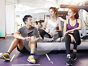 Asian young people talking in gym