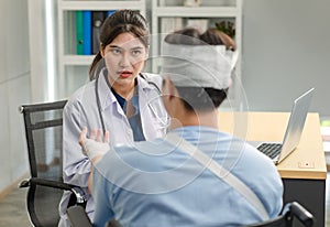 Asian young professional female practitioner doctor in white lab coat with stethoscope holding skull model showing explaining to