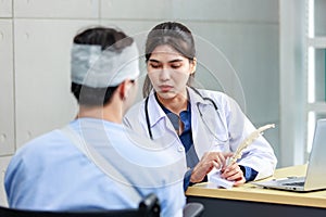 Asian young professional female practitioner doctor in white lab coat with stethoscope holding skull model showing explaining to