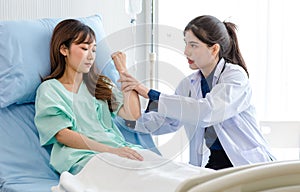 Asian young professional female practitioner doctor in white lab coat with stethoscope holding touching checking monitoring photo