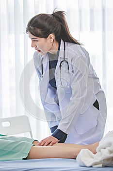 Asian young professional female practitioner doctor in white lab coat with stethoscope holding touching checking monitoring photo