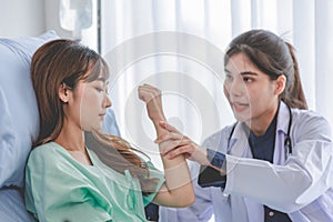 Asian young professional female practitioner doctor in white lab coat with stethoscope holding touching checking monitoring photo
