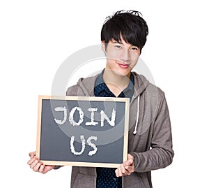 Asian young student with blackboard showing a phrase of join us