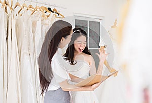 Asian young woman bride shocked bill with cost,Woman designer making adjustment in studio