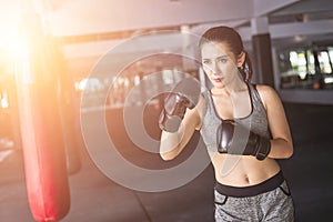 Asian young woman doing exercise with Thai boxing Muay Thai eq photo