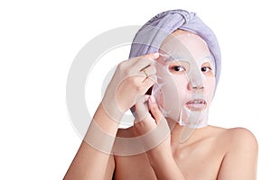 Asian young woman face, girl applying facial peel off mask