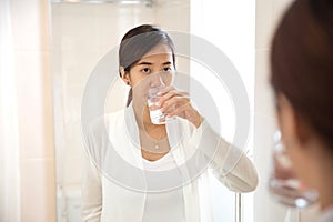 Asian young woman gargle on her mouth after tooth brushing